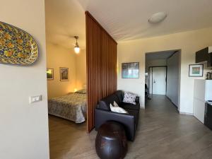 a living room with a couch and a bed at Suite Laghetto EUR in Rome