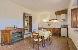 a kitchen with a table and chairs in a room at THR-Apartment with 2 bedrooms, 5 beds, 2 bathrooms, air conditioning and private outdoor space in a residence with swimming pool not far from Florence in Grassina