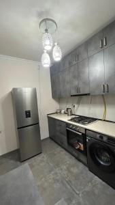a kitchen with a stainless steel refrigerator and a stove at 4cosy apartment with view Ararat in Gukasavan