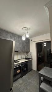 a kitchen with a refrigerator and a stove top oven at 4cosy apartment with view Ararat in Gukasavan +8 photos