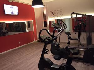 a gym with two cardio machines in a room at Hotel Petrarca in Boara Pisani