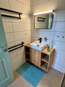 a bathroom with a sink and a mirror at Mountain Lodge Istria - Stone Lodge II in Roč +37 photos