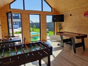 a room with a pool table and a ping pong table at Osada Jantar - Holiday in Jantar