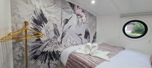 a bedroom with a flower mural on the wall at Luxury Boat Stay Liverpool sleeping 6 WiFi in Liverpool