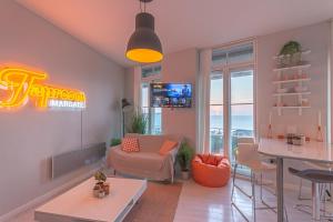 a living room with a couch and a table at Seaview Apt Turner Contemporary, Margate By Adliv in Margate