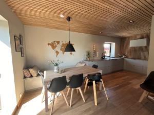 a kitchen and dining room with a wooden table and chairs at Villa på Jeløya in Moss