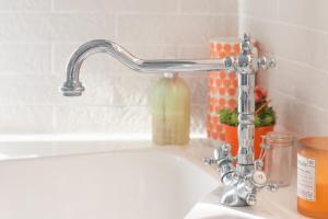 a sink with a faucet on a white sink at Seaview Apt Turner Contemporary, Margate By Adliv in Margate +30 photos