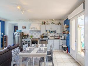 a kitchen with a table and chairs in a room at Holiday Home la maison du bonheur by Interhome in Primelin +32 photos