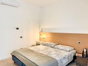 a bedroom with a large bed in a room at Apartment DaNina by Interhome in Abbadia Lariana