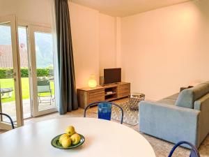 a living room with a table and a couch at Apartment DaNina by Interhome in Abbadia Lariana