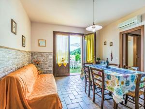 a living room with a table and chairs and a window at Apartment Bellavista-1 by Interhome in Castellina Marittima