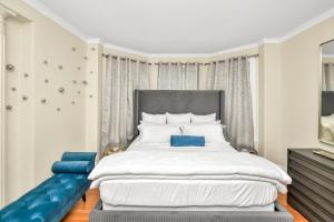 a bedroom with a large bed with blue accents at Comfort Stay III in Boston