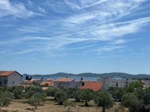 a view of a city with buildings and a blue sky at Apartman Lorna in Turanj