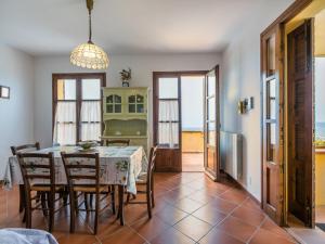 a kitchen and dining room with a table and chairs at Apartment Bellavista-2 by Interhome in Castellina Marittima