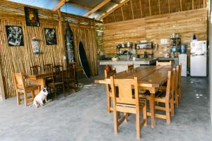 a dog sitting next to a wooden table and chairs at katana siargao in Catagnan