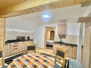 a kitchen with a table and chairs in a room at Хатинка in Yaremche