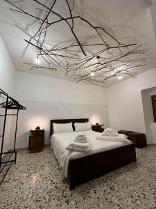 a bedroom with a large bed with a branch ceiling at B&B La Majella Me in Abbateggio