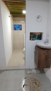 a bathroom with a sink and a toilet and a mirror at Alojamiento ideal, las palmas in Ruiosucio