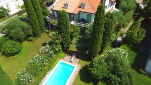 an aerial view of a house with a swimming pool and trees at Villa Bionda- unique gem with private pool on Lake Garda in Sirmione