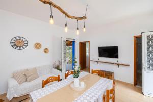 a living room with a table and a couch at Korali Sea House in Archangelos