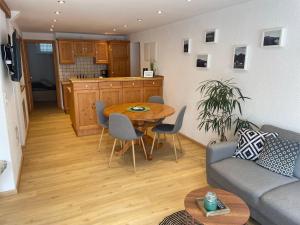 a living room with a table and a kitchen at Das kleine Gasthaus in Kamp-Bornhofen