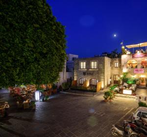 a building with a parking lot at night at Arthur Suites in Old Town in Rhodes Town