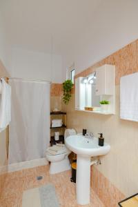 a bathroom with a sink and a toilet at Korali Sea House in Archangelos +29 photos
