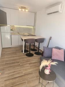 a living room with a couch and a table at Rita Apartments in Makarska