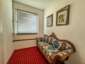 a living room with a couch and a window at Apartmaji Vogelnik in Radovljica +12 photos