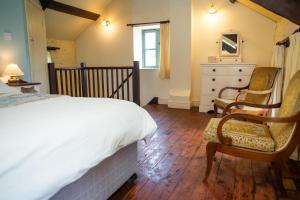 Ένα ή περισσότερα κρεβάτια σε δωμάτιο στο The Coach House New Quay