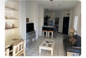 a living room with a couch and a table at Cabo Oasis At Misiones in Cabo San Lucas