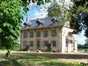 a large house with a roof on top of it at Domaine de Savigny in Saint-Saulge