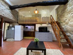 a kitchen with a staircase and a table in a room at Quinta de Souto Velho in Terras de Bouro