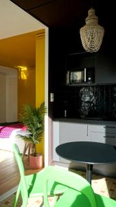 a table and chairs in a room with a bedroom at Studio - Saint-Michel in Le Havre