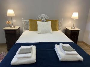 a bedroom with a bed with towels on it at Quinta de Souto Velho in Terras de Bouro +91 photos
