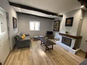 a living room with a couch and a fireplace at Quinta de Souto Velho in Terras de Bouro