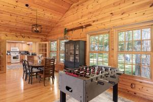 a kitchen and dining room with a stove in a cabin at Torch Lake House Central Lake in Central Lake