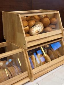 a wooden box filled with different types of bread at President Hotel Montfort in Ždiar