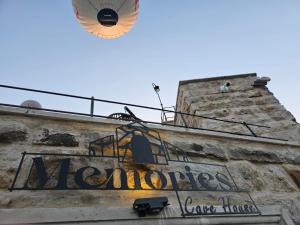 a sign on the side of a building with a lamp at Memories Cave House in Uçhisar +95 photos
