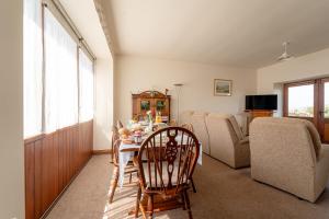 a living room with a table and chairs and a couch at Farm House, Breath Taking Views in Clitheroe