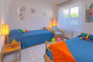 a childrens bedroom with two beds and a chair at Villaggio Turistico Internazionale in Porto Recanati +31 photos