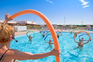 a group of people playing in a swimming pool at Villaggio Turistico Internazionale in Porto Recanati