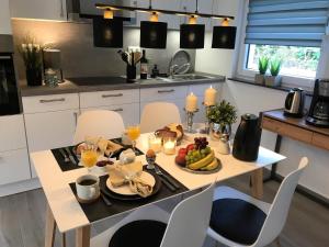 a kitchen with a table with food and fruit on it at Ferienhaus Stamer in Eckernförde