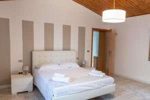 a bedroom with a white bed with towels on it at Casa Vacanze Francesca in Mondolfo