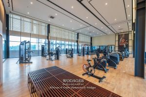 a gym with treadmills and exercise equipment in a building at Mossaz at Empire Damansara by Wodages in Kuala Selangor
