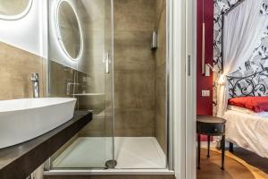 a bathroom with a shower and a sink and a bed at ALE HOUSE in Arezzo