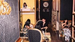 a group of people sitting in chairs in a room at The Clock Hostel & Suites in Cartagena de Indias