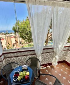 a plate of fruit on a table in front of a window at Budget-Apart Caronte in Riviera del Sol, Mijas Costa in Mijas Costa