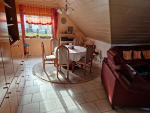 a dining room with a table and a couch at Casa Ulla am Hallenbad in Haiger +4 photos