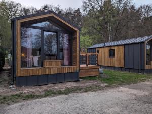 a cabin with a large window and a deck at Amira in Stuer